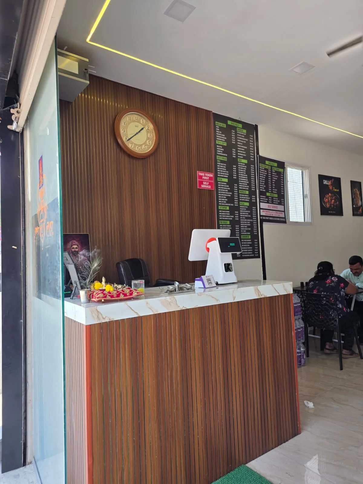 Wooden billing counter at Ram Krishna Hari pure veg restaurant Katraj